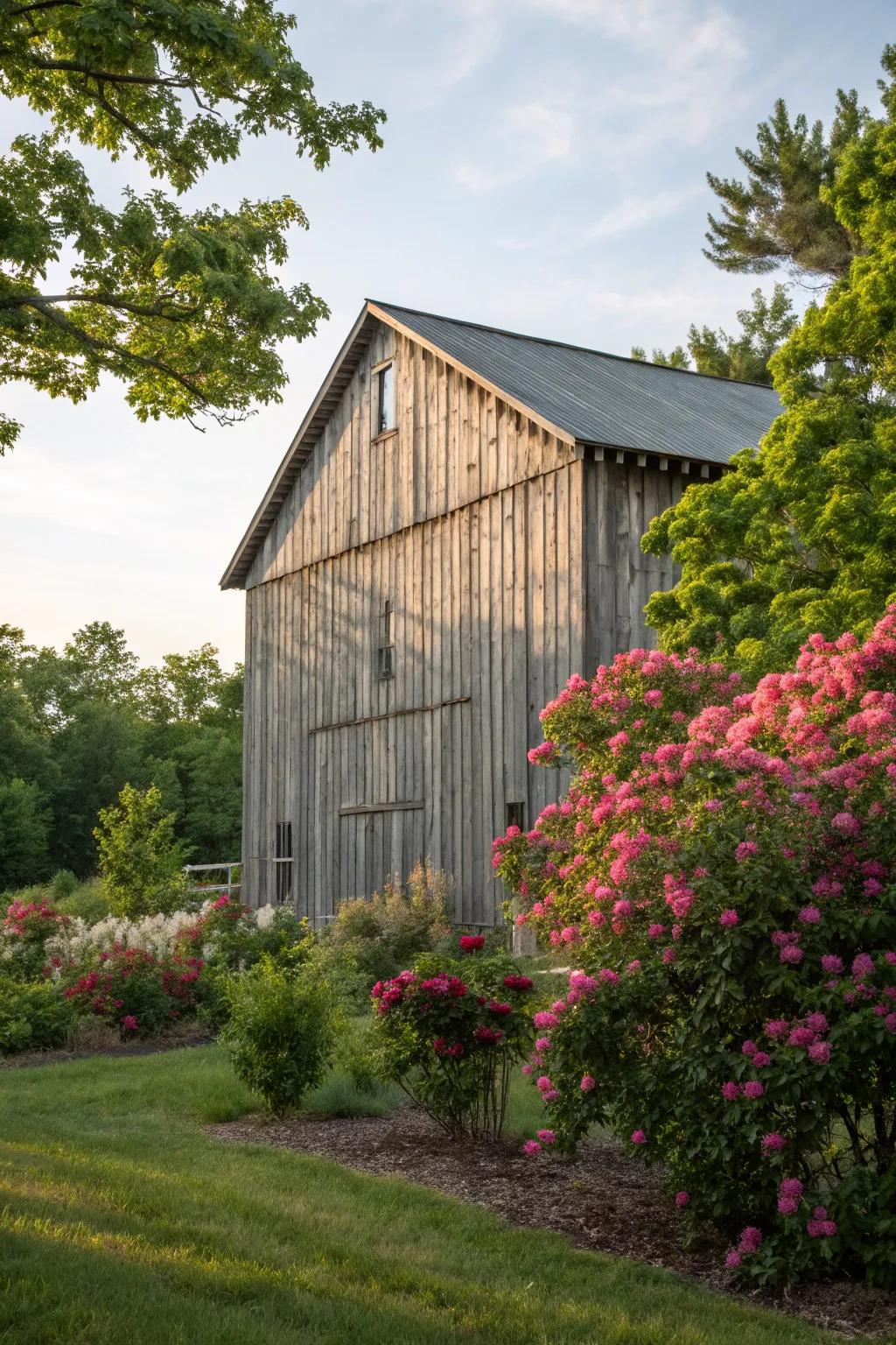 A barn showcasing classic board and batten siding set against a lush green backdrop.