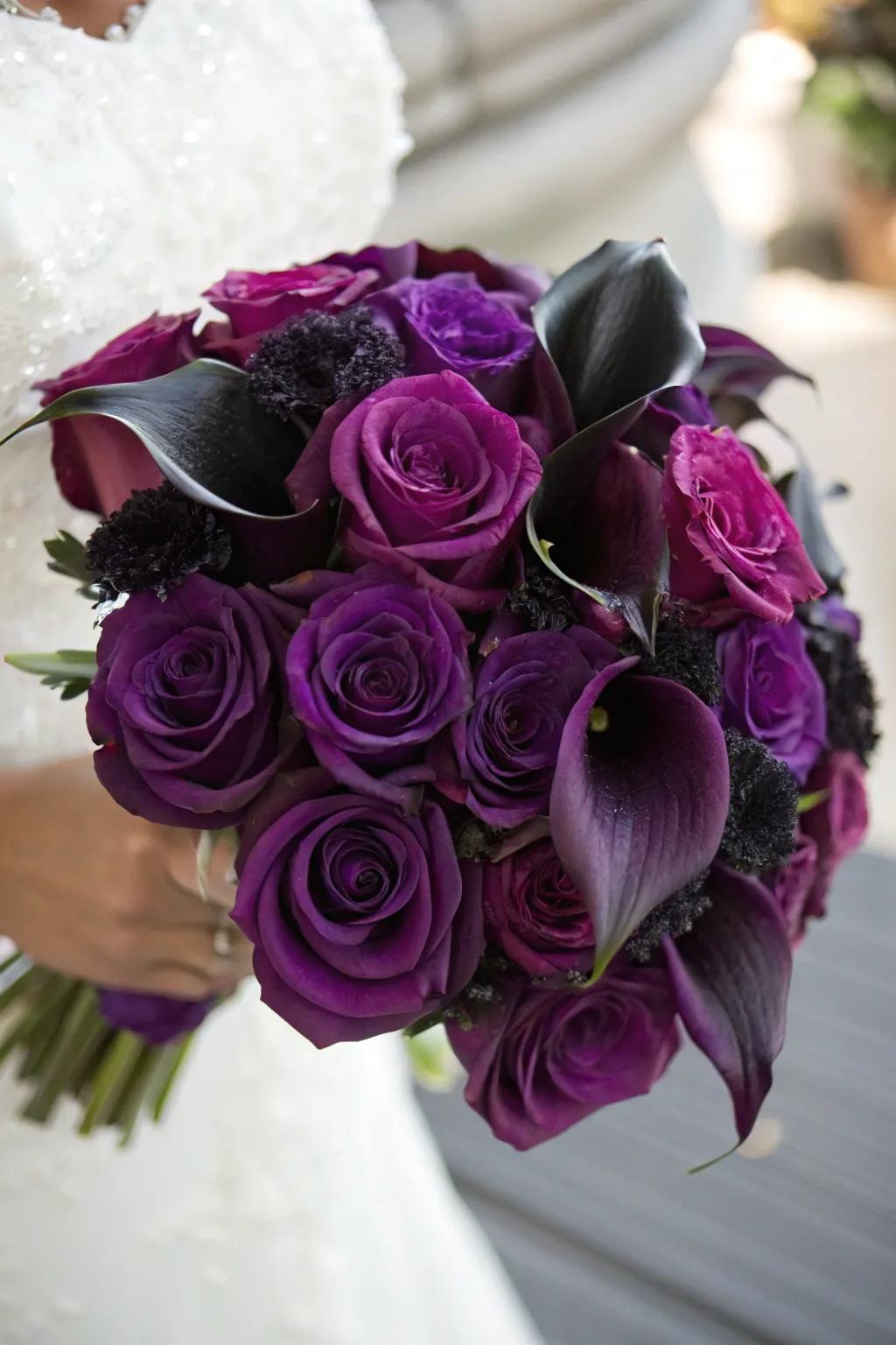 A breathtaking bouquet of deep lavender roses and midnight calla lilies.