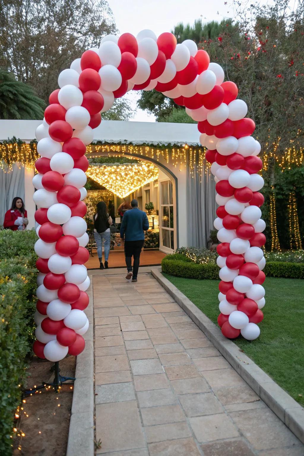 Welcome your guests with a charming candy cane balloon arch.