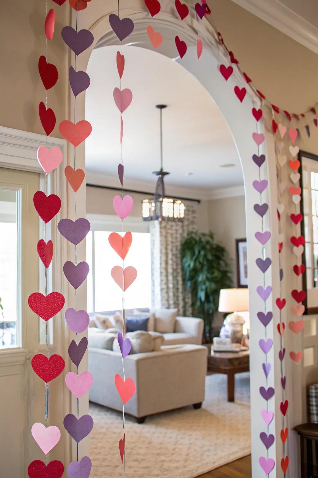 A bright paper heart garland adding charm to a decorated archway.