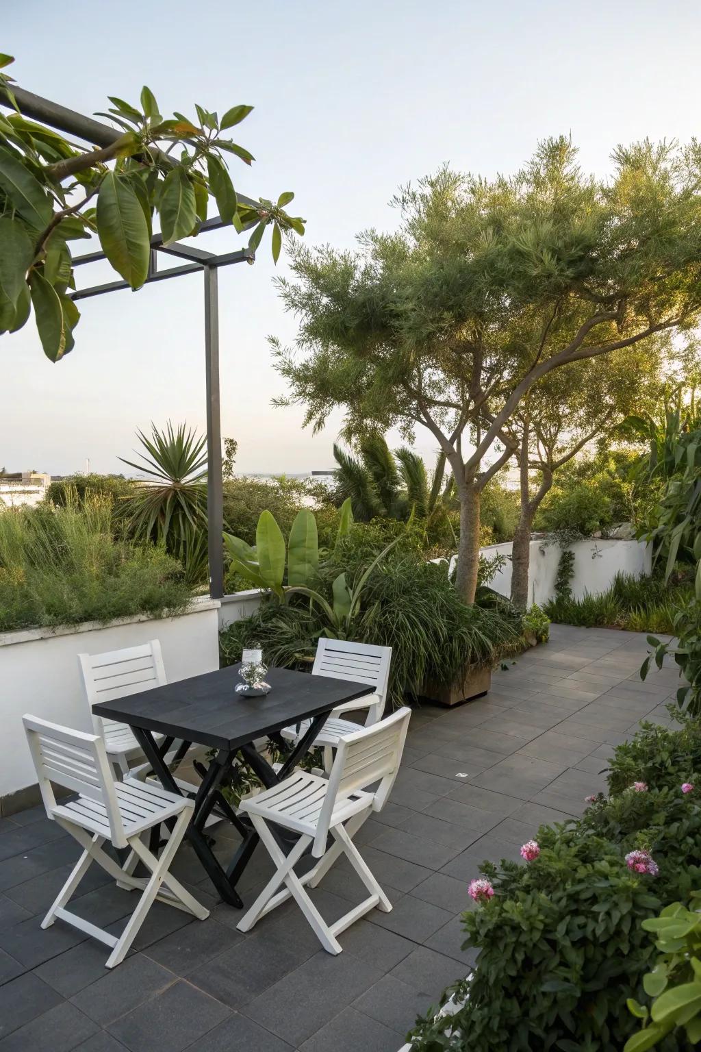 A stylish patio featuring a black table and white chairs, ideal for sophisticated gatherings.