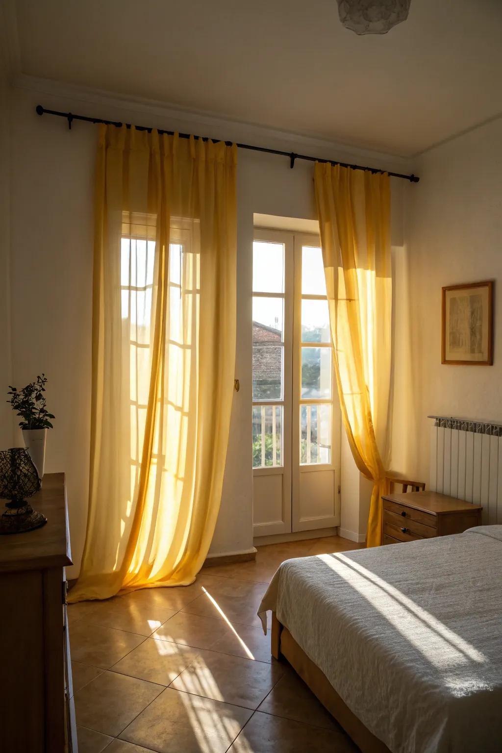 Airy yellow window coverings draw in light and create a spacious feel in the bedroom.