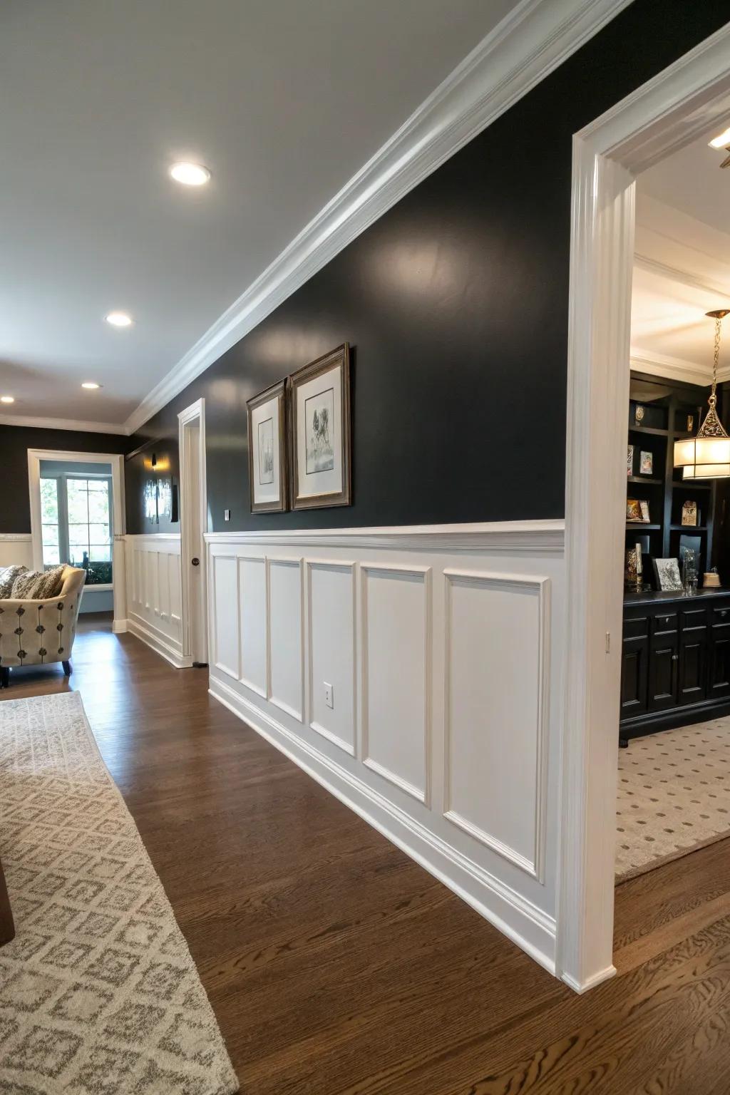 A room with a half black accent wall paired with white wainscoting for a balanced effect.