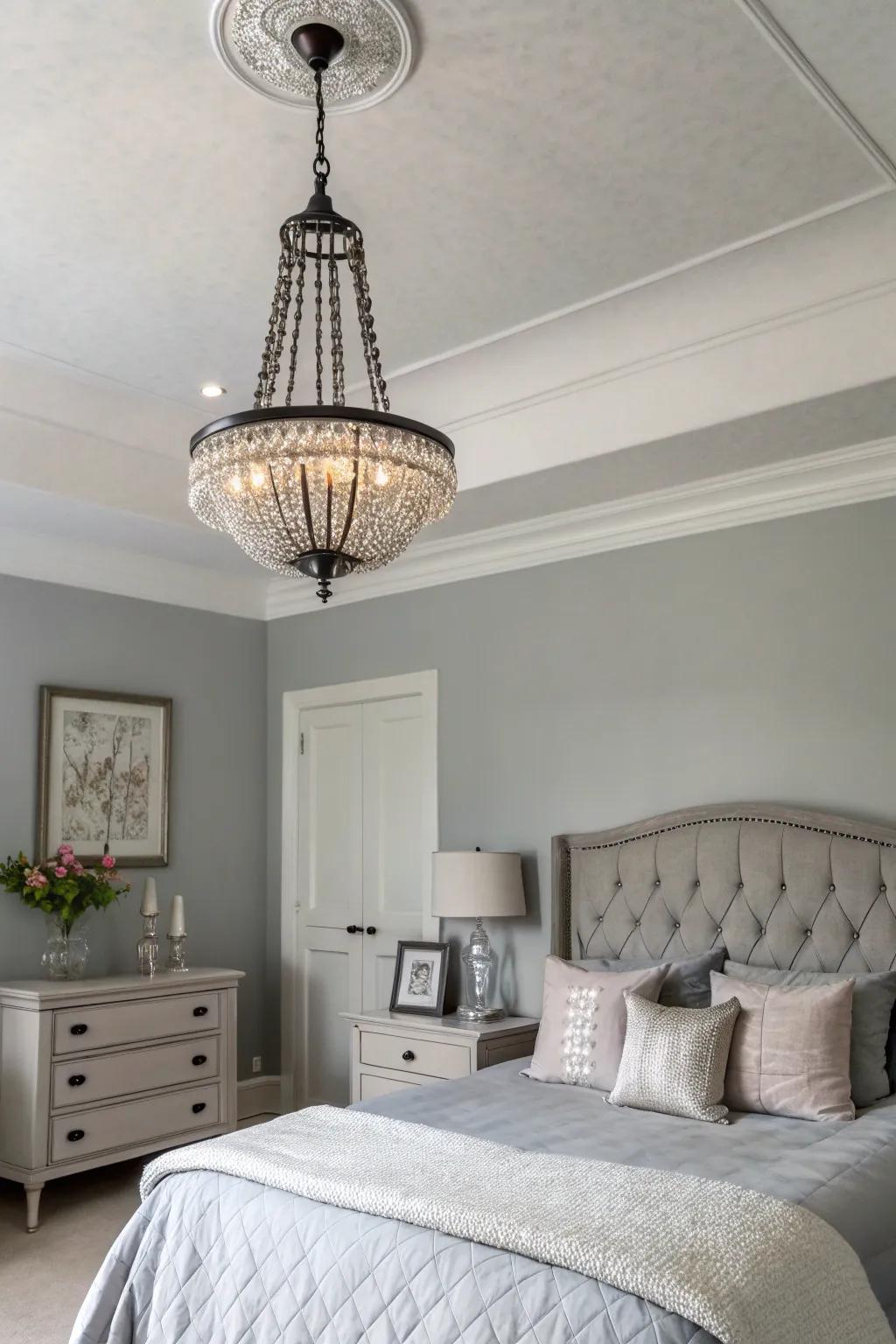 Lighting fixtures serve as artistic elements in a serene gray bedroom.