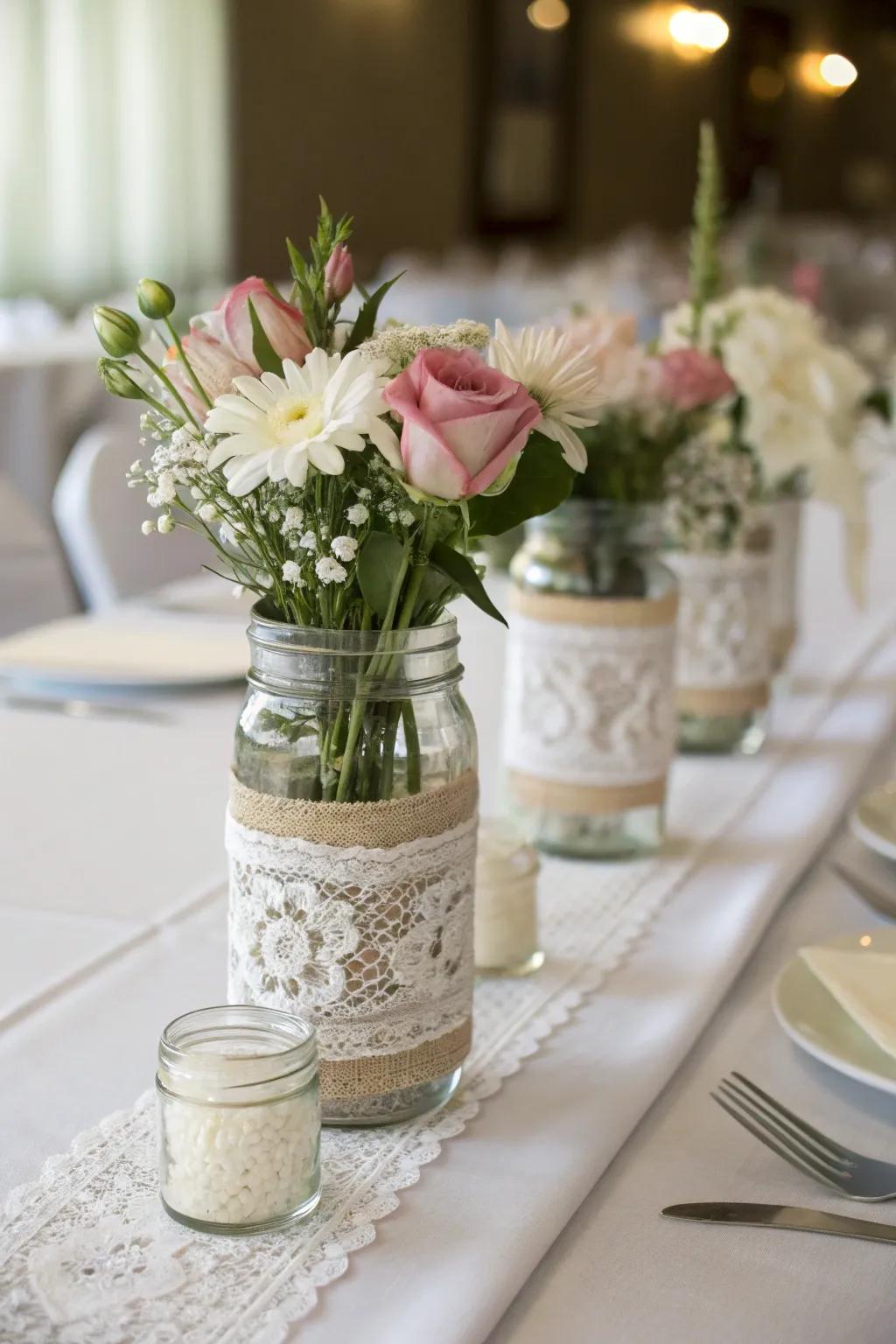 Mason jars wrapped in lace for an elegant centerpiece.