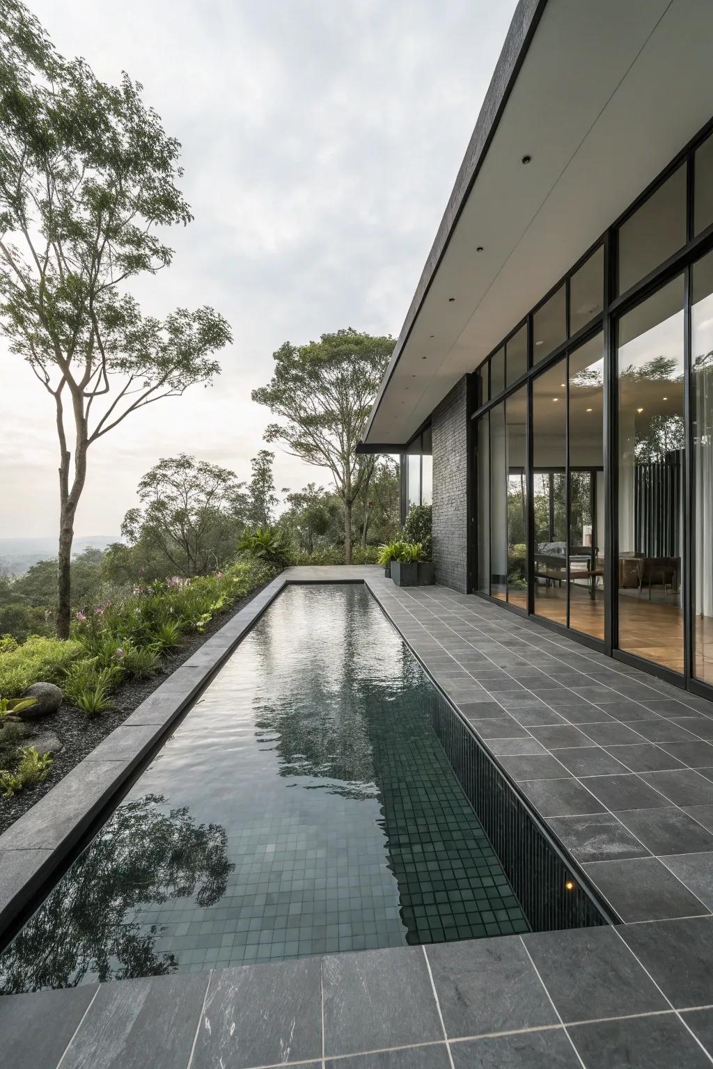 Charcoal tiles offer a dramatic and sophisticated poolside look.