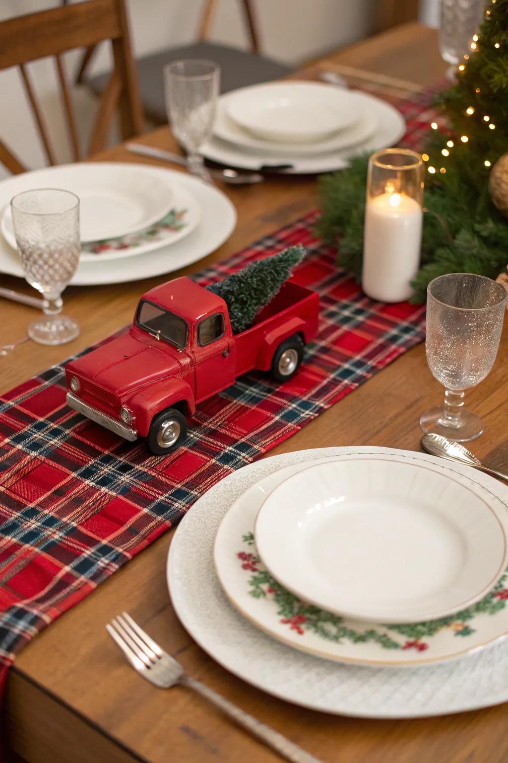 Festive table setting with a red truck and plaid table runner.