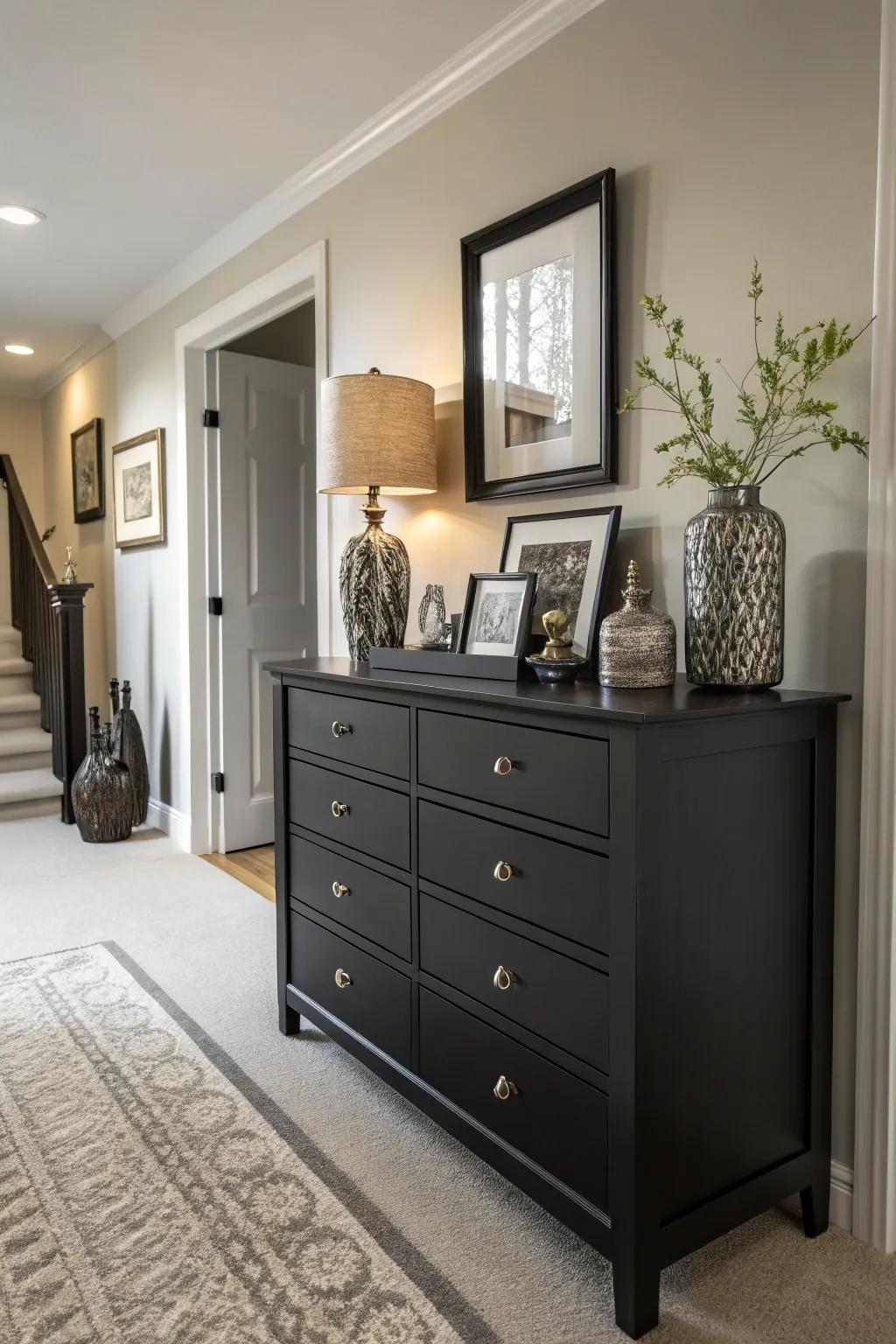 A black dresser providing chic storage in an elegant hallway.