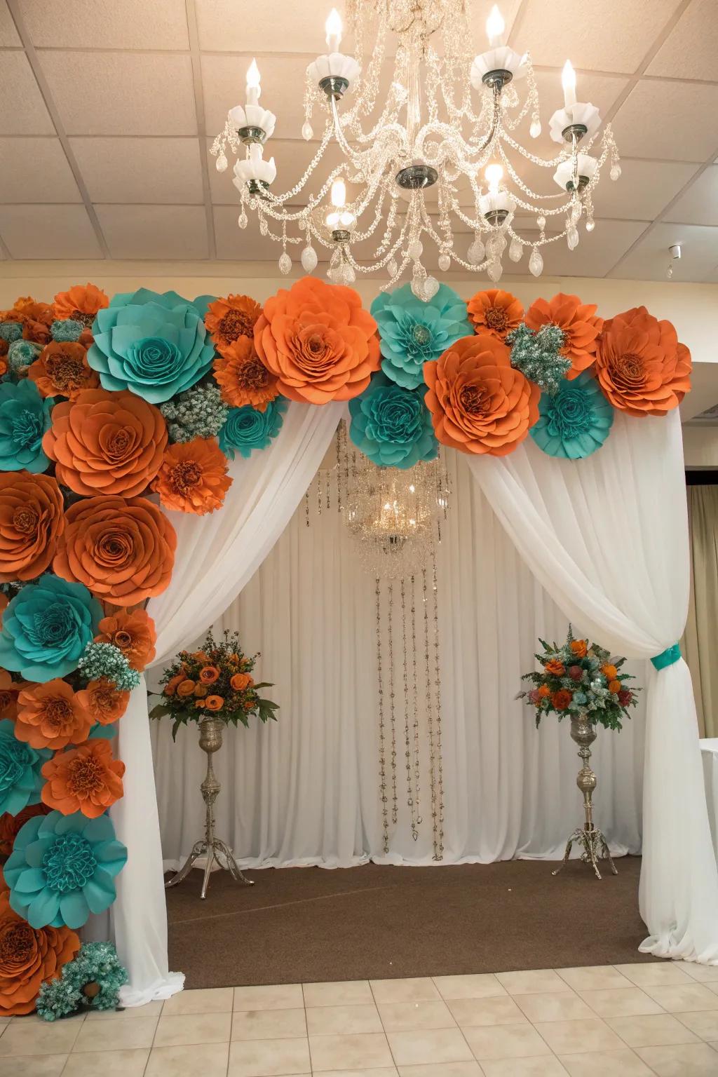 A playful photo backdrop with sunset orange and seafoam green flowers.