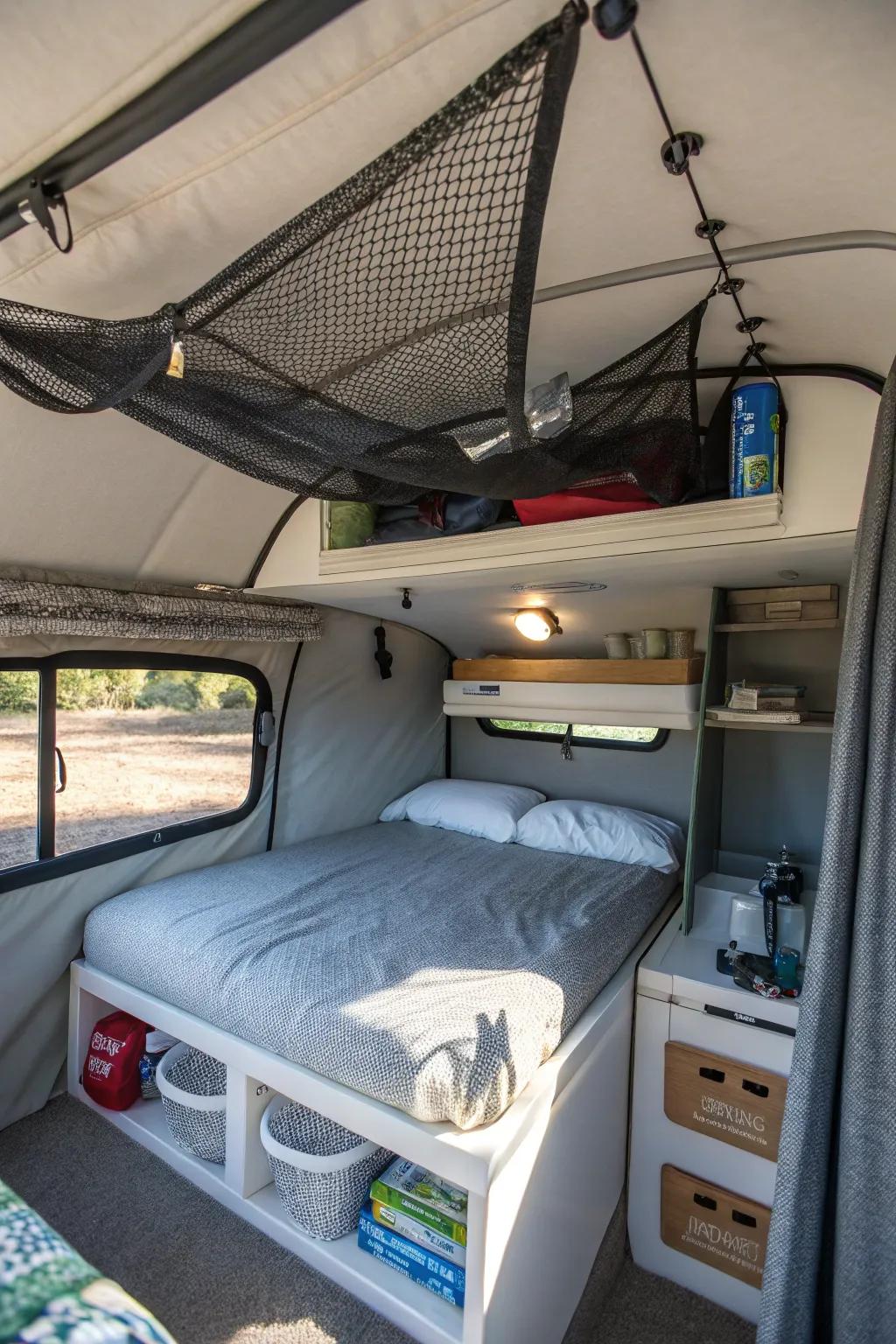 Ceiling storage nets help keep lightweight items organized inside a camper.