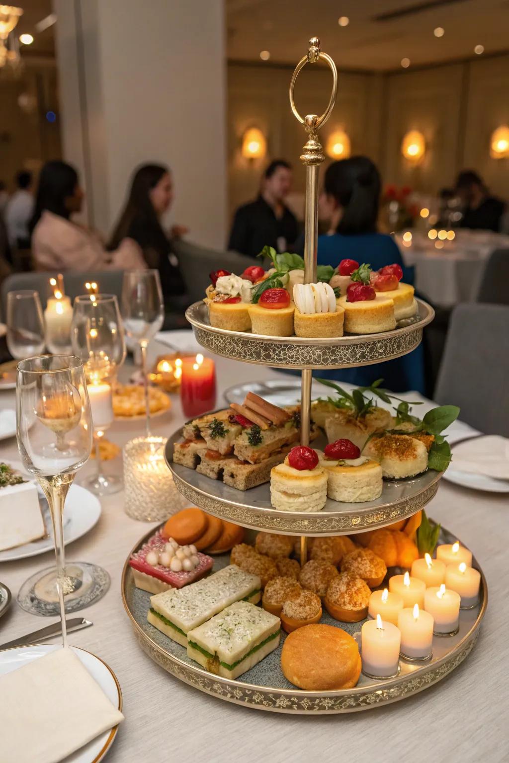 A dining table set for a party featuring a tiered tray of snacks.