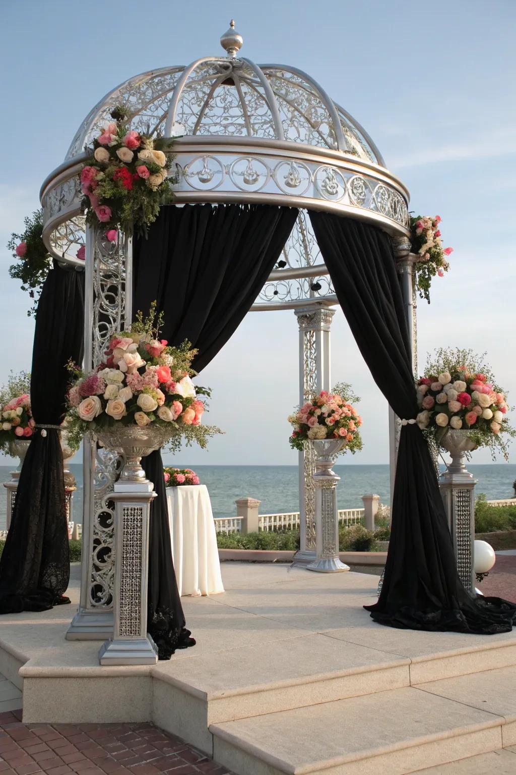 A distinct ceremony arch featuring coal and shimmer elements.