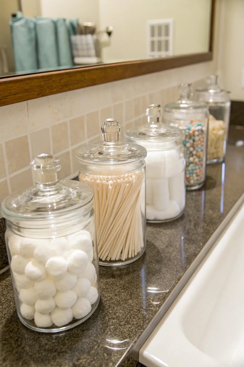 Glass jars offer a stylish means to store small bathroom essentials.