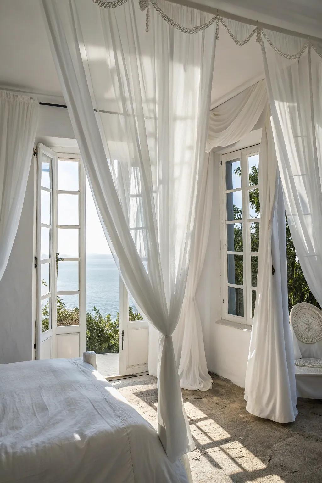 Elegant drapes elevate the breezy sensation of a white bedroom.