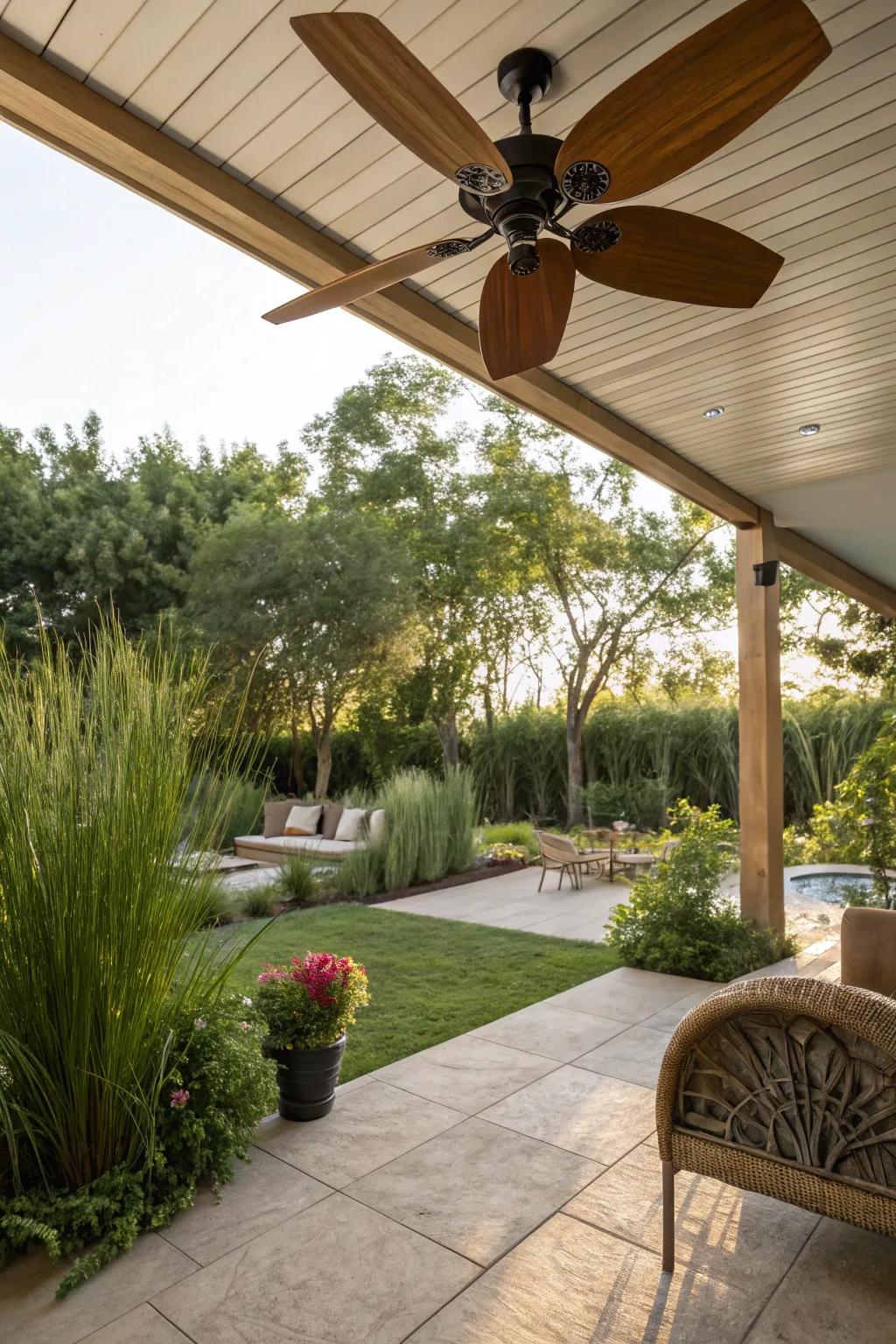 A nature-inspired patio with a ceiling fan featuring wooden blades.