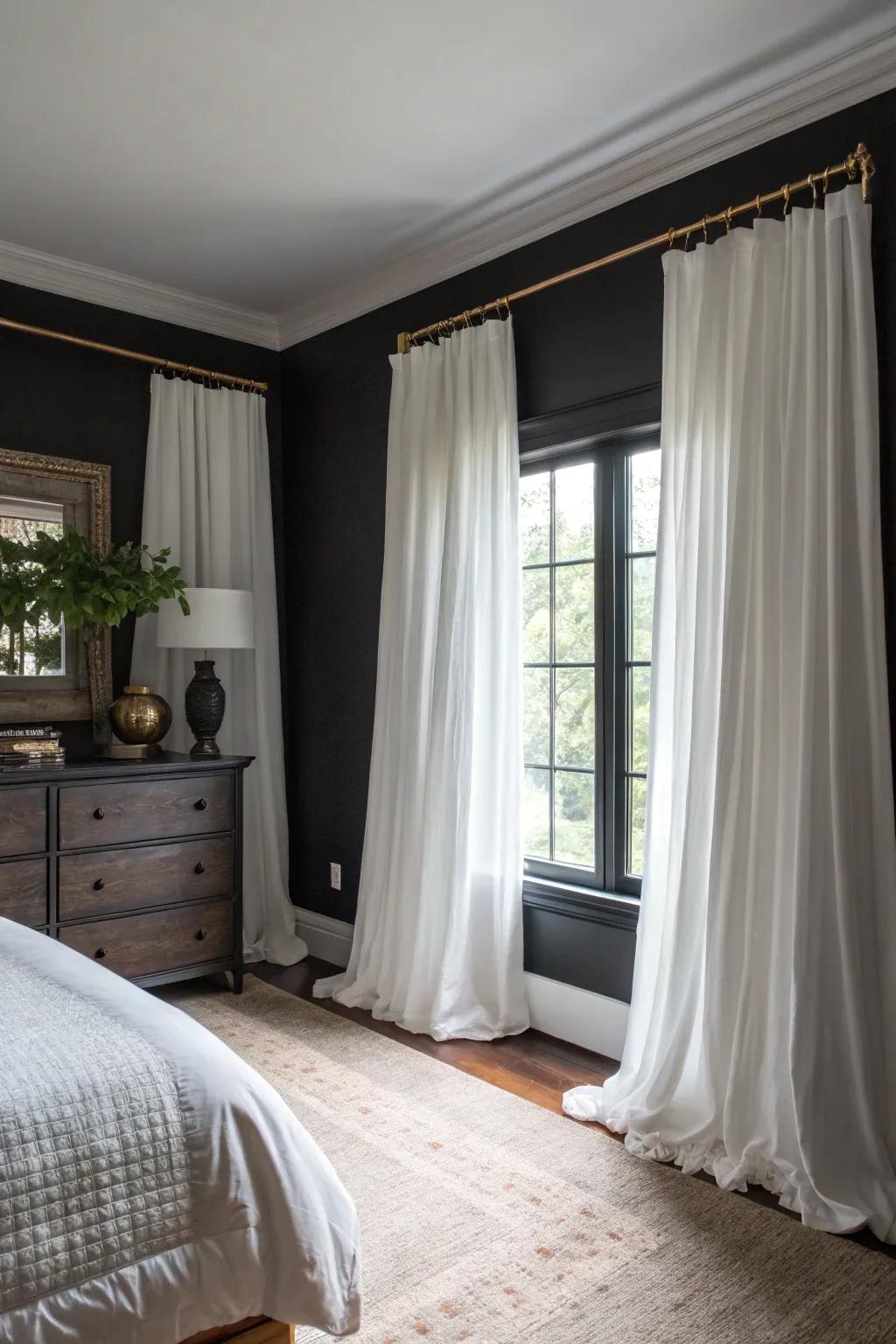 White curtains provide a striking contrast to dark elements in the room.