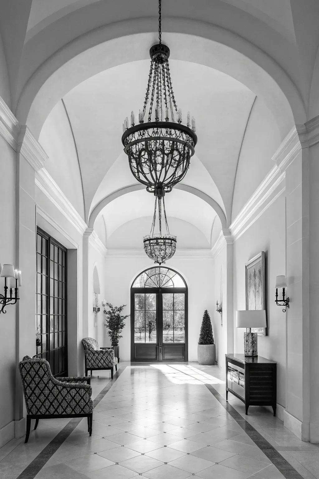 A monochrome chandelier adds sophistication to this modern foyer.