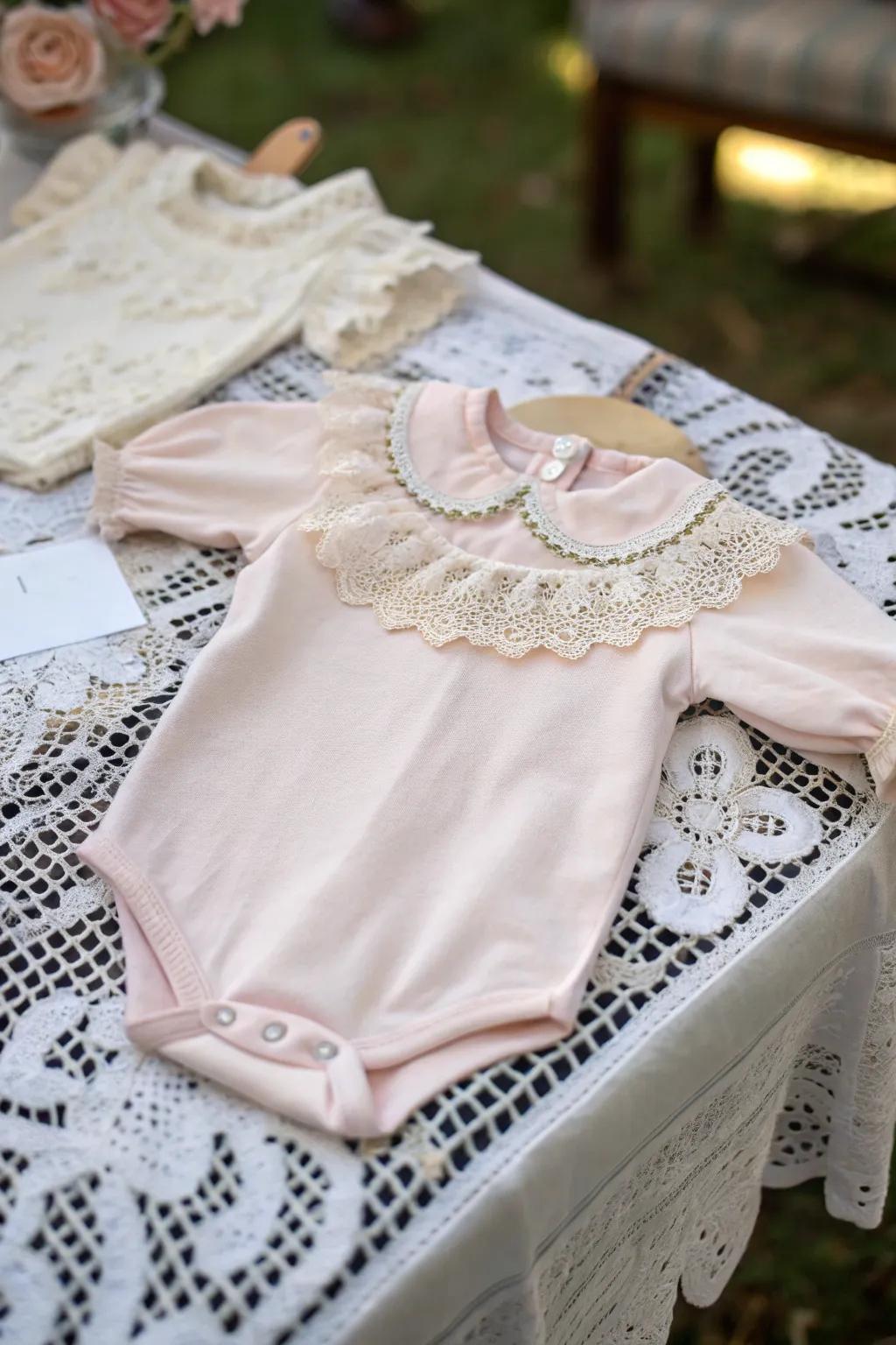 An elegant onesie featuring vintage trim touches.