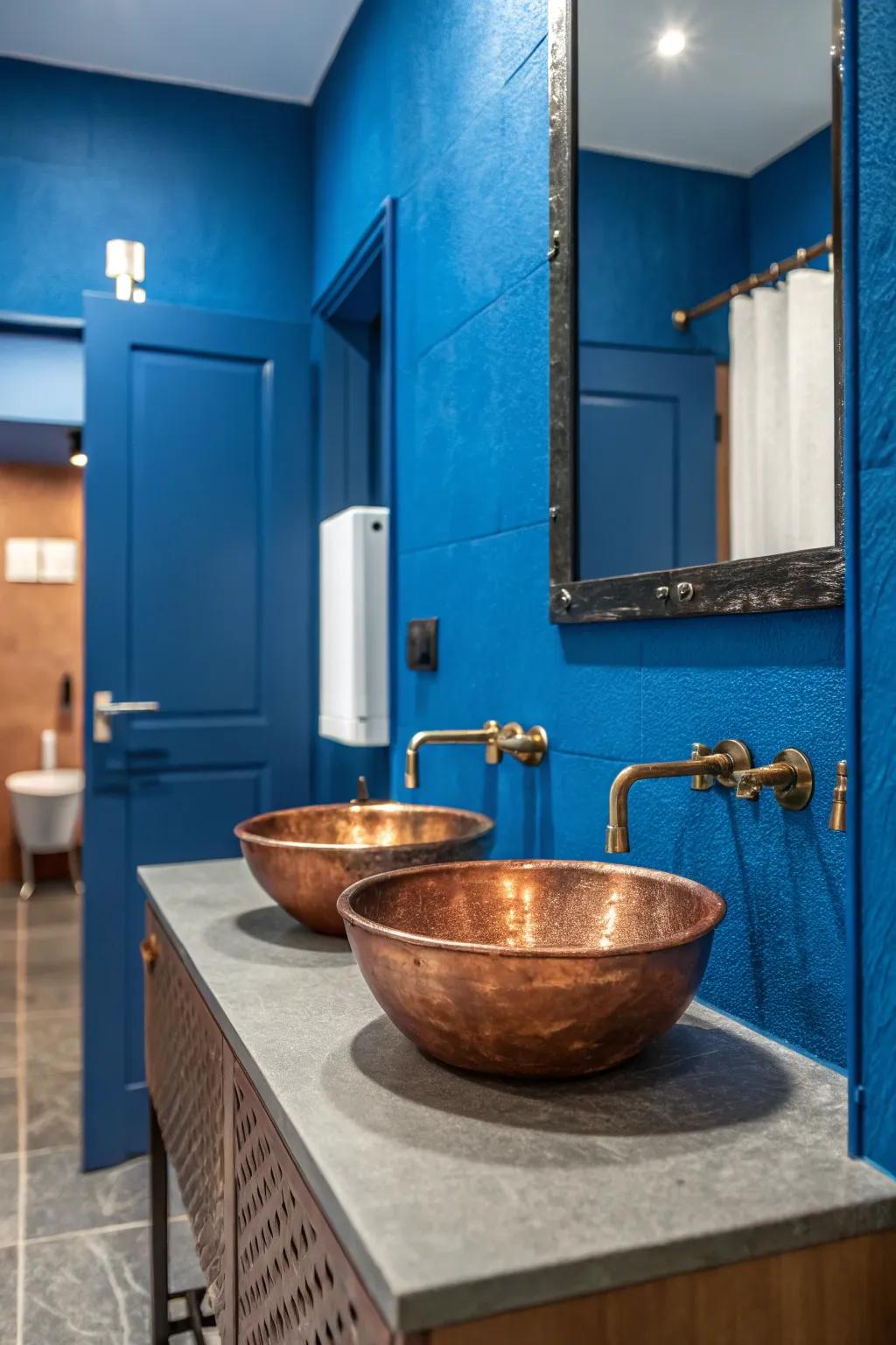 The warm tones of this copper sink are strikingly set off by the use of deep blue walls.