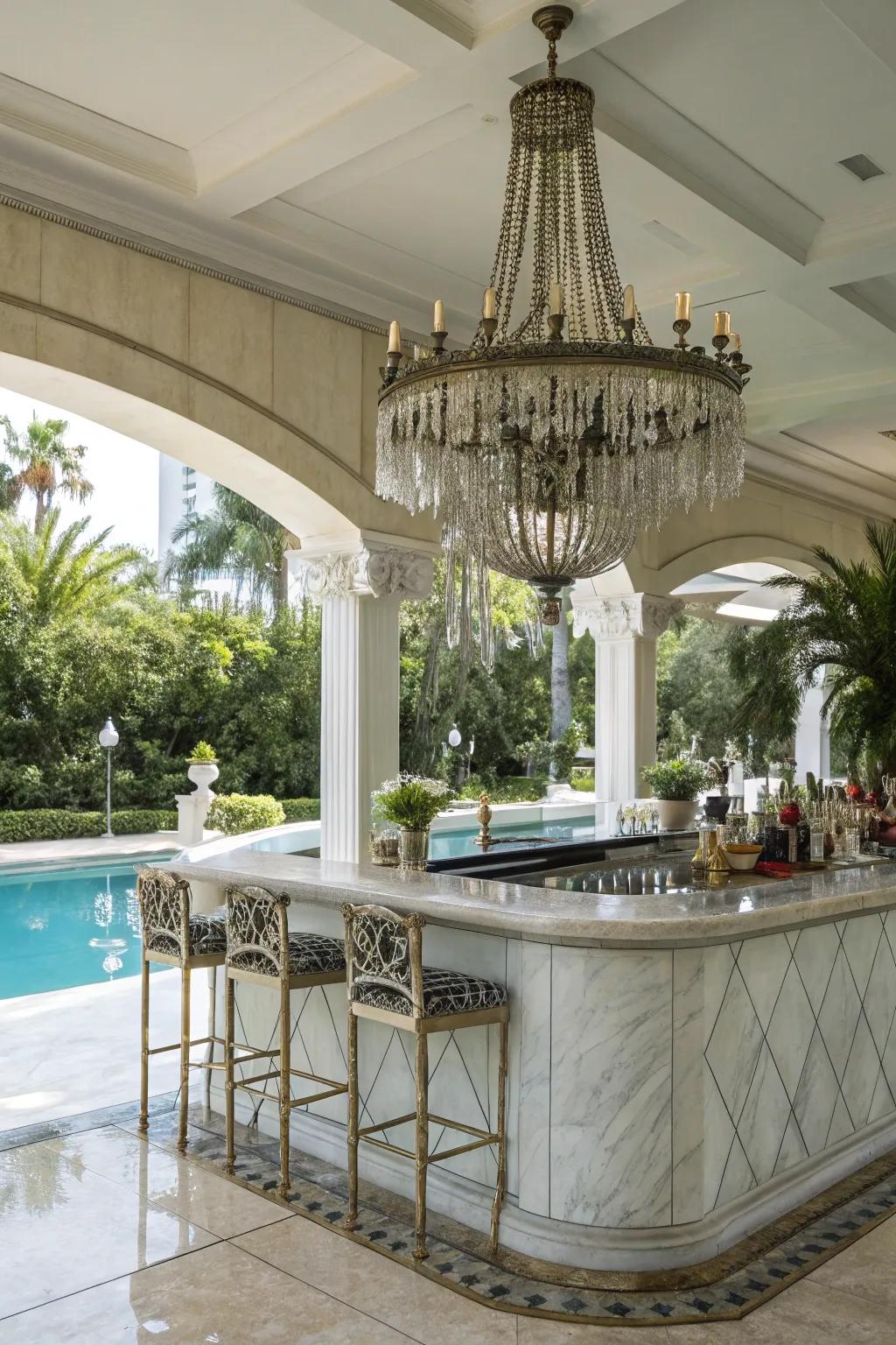 A marble bar with a chandelier elevates your outdoor space with elegance.