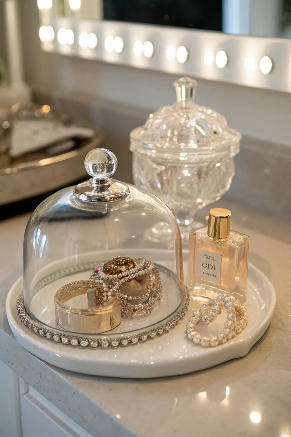 Jewelry plus perfume containers fashion a luxurious showcase underneath a glass cover.