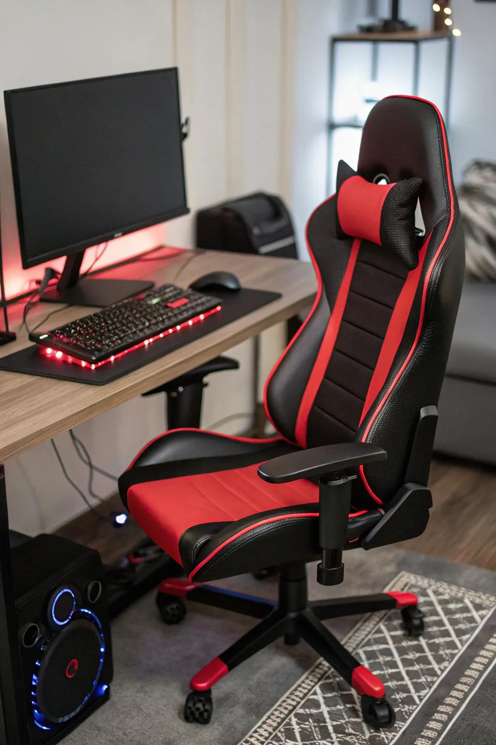 A fashionable black and red comfort chair sits ready for action in a gaming setup.