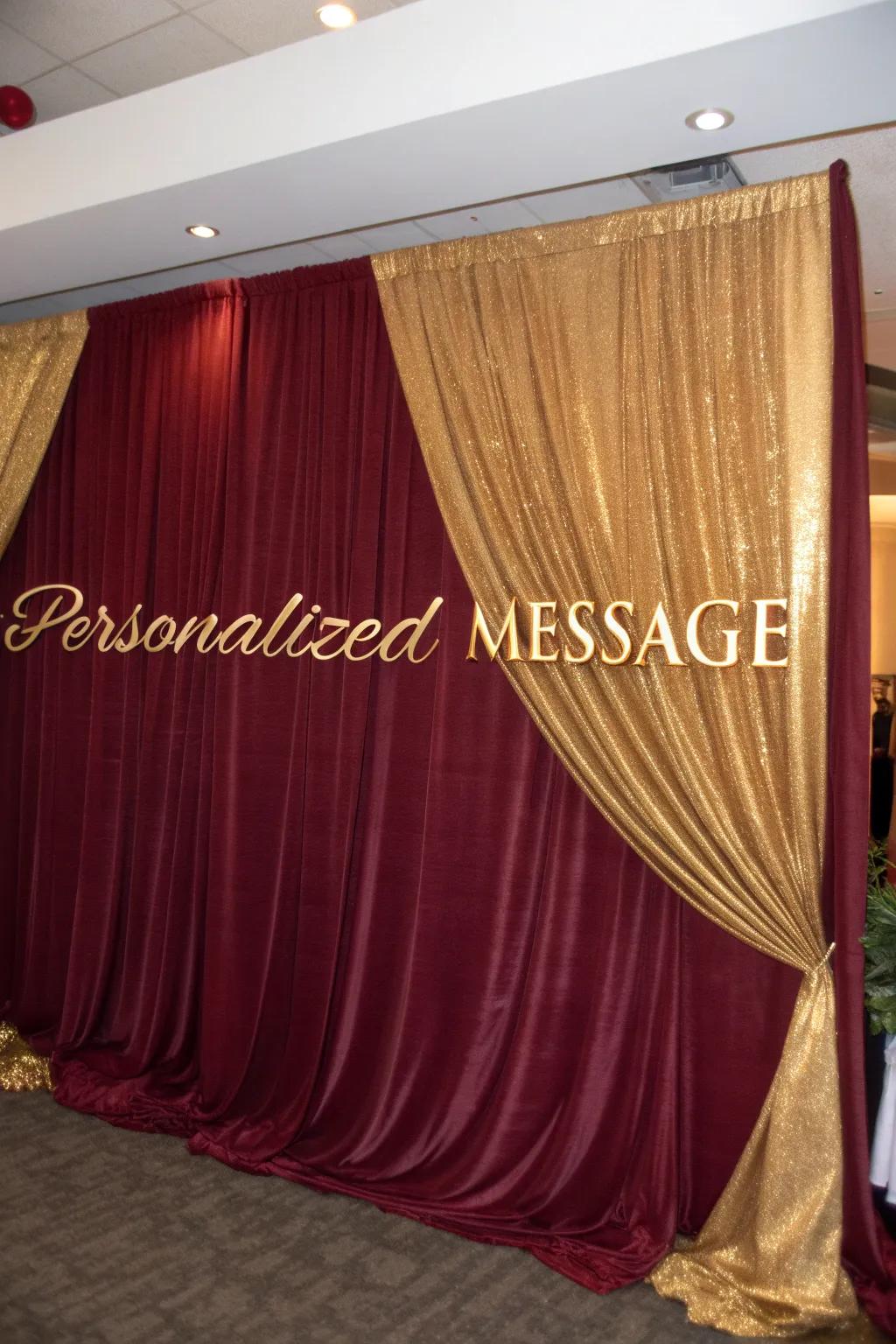 Produce a captivating point of focus by utilizing lavish deep red and gold fabric backdrops.