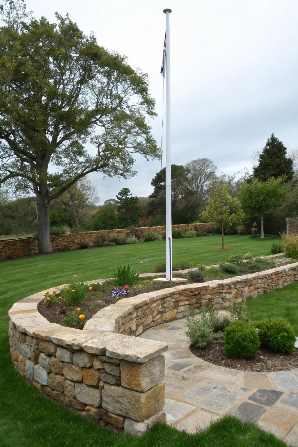 Elegant rock borders frame a freedom pole, amplifying its presence.