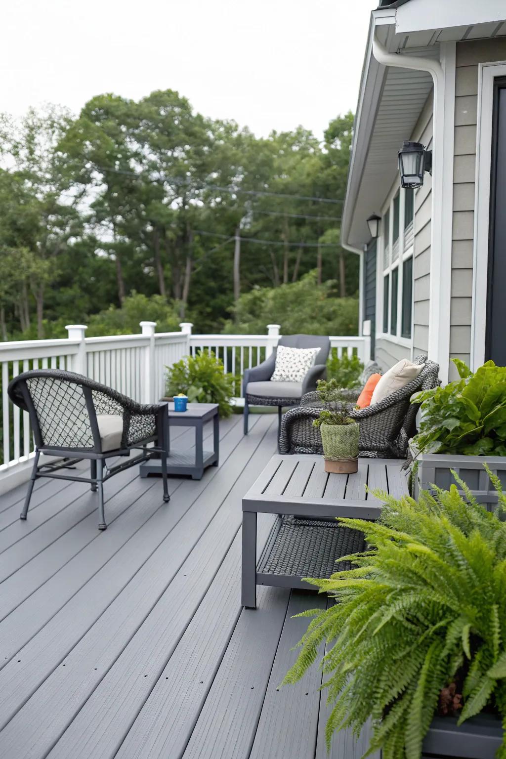 A modern slate-toned deck flowing seamlessly with fashionable outdoor furniture.