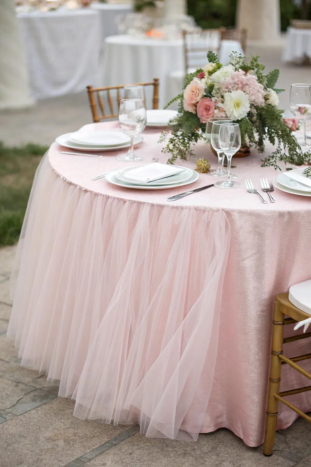 A princess-worthy table setup with soft pink net.
