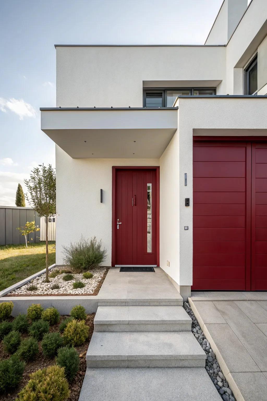 A modern home with a deep red door, balancing warmth and minimalism.