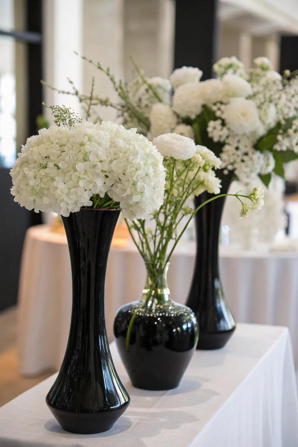 Elegant white flowers paired with black vases.