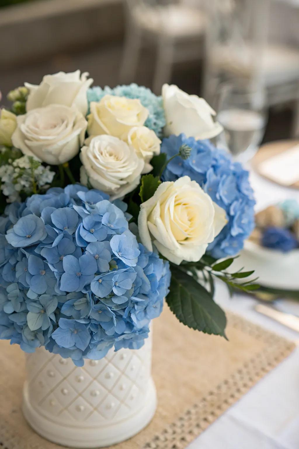 Blue hydrangeas paired with white roses offer a timeless elegance.