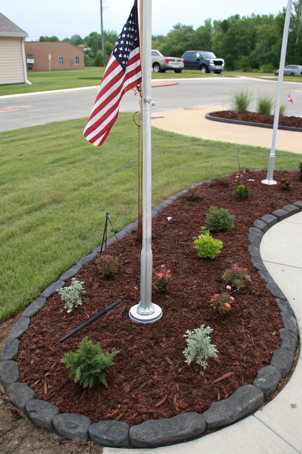 Ornamental ground cover adds a clean, polished look to a freedom pole landscape.
