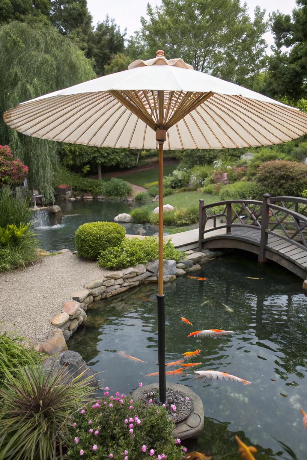 A koi pond shielded by a large garden umbrella.