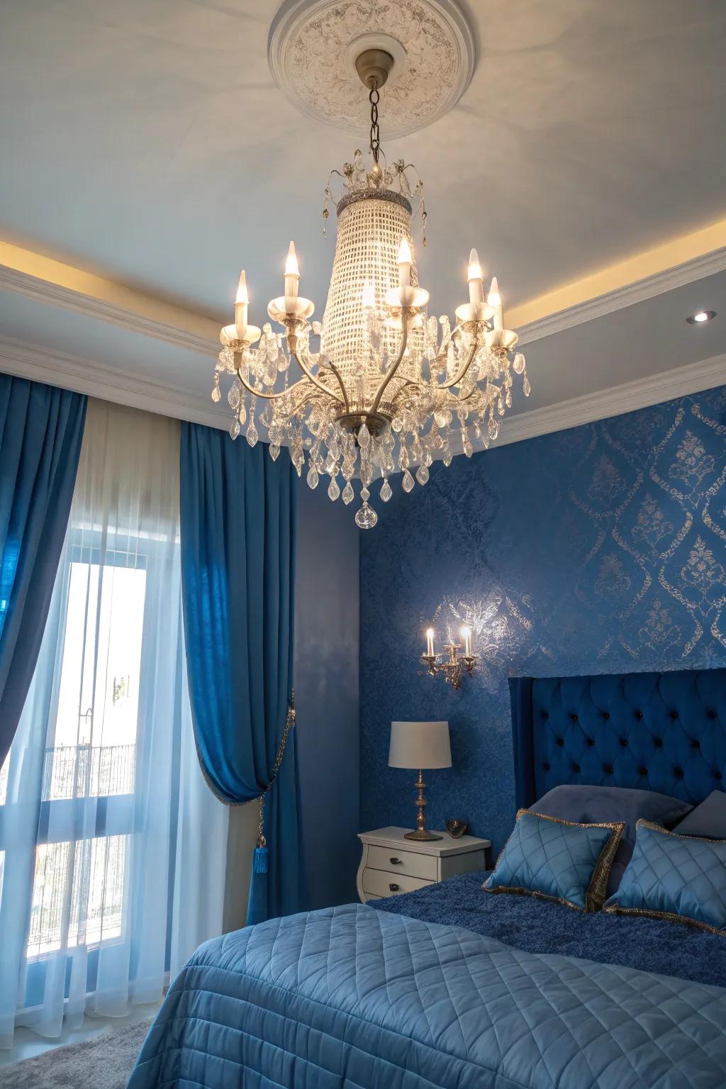 A sparkling chandelier injects refinement into a bedroom styled with indigo accents.