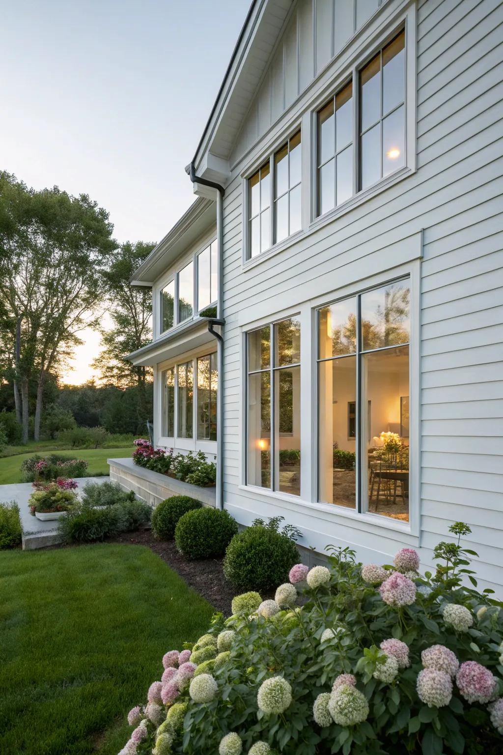 A bright and airy white siding house with expansive windows.