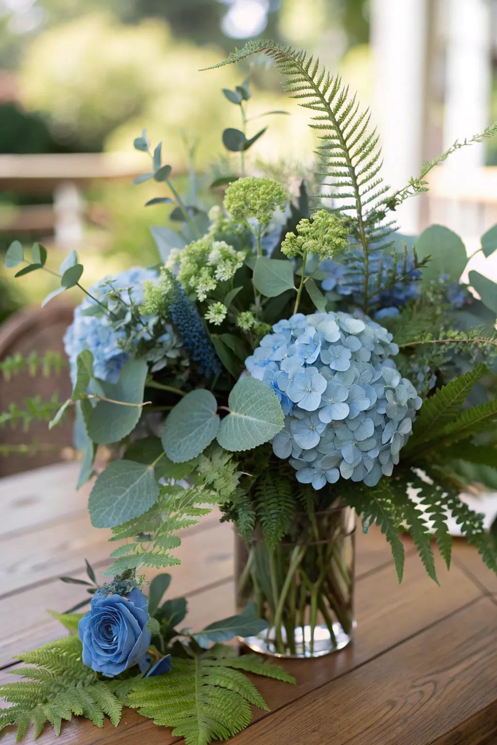 Greenery mixed with blue hydrangeas creates a rich, layered effect.