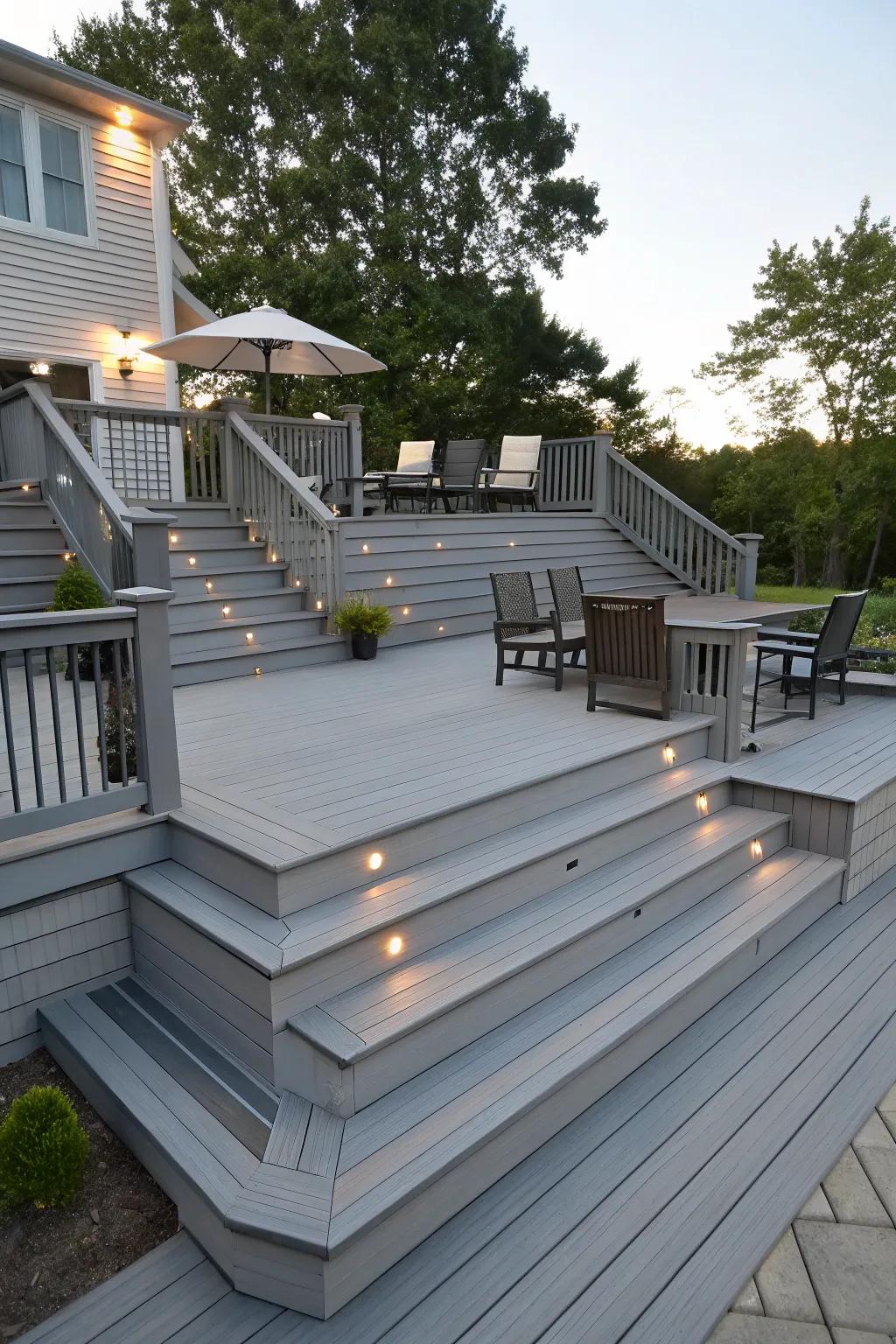 A multi-level grey deck creating distinct zones for different uses.