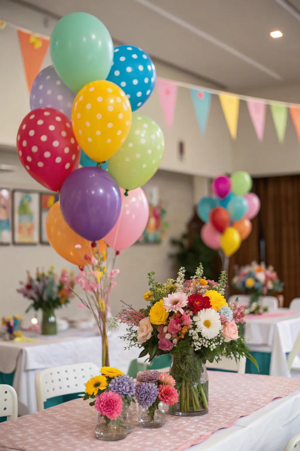 A festive table featuring balloon bouquets and coordinating floral centerpieces.