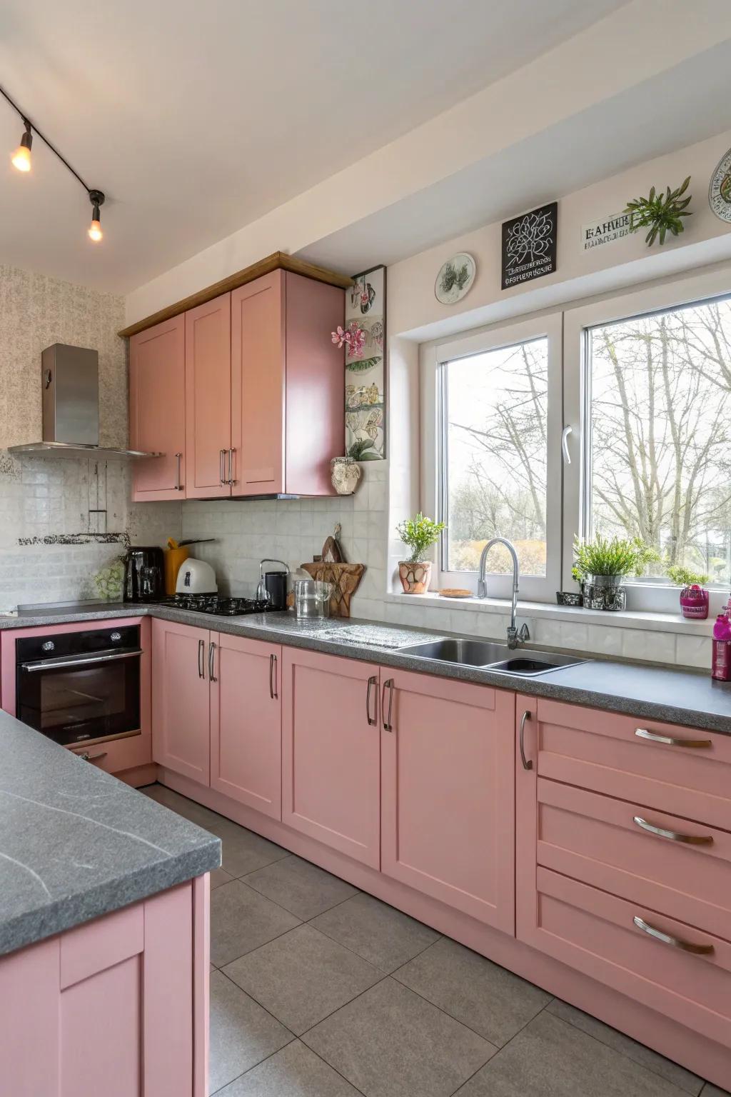 Striking rose-tinted cabinetry with elegant grey worktops.