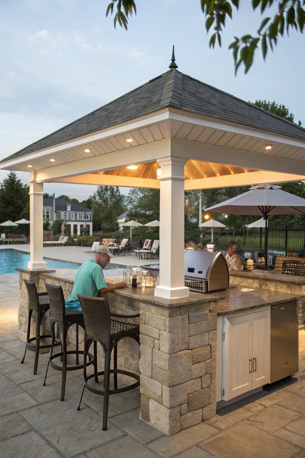 An outdoor kitchen pavilion is ideal for cooking and entertaining by the pool.