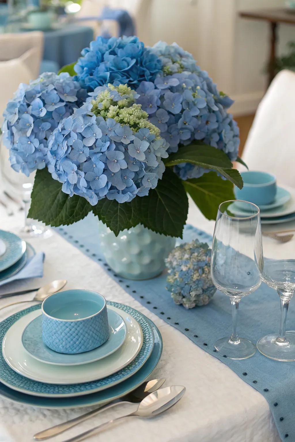 A thematic table setting with blue accents complements the hydrangeas.