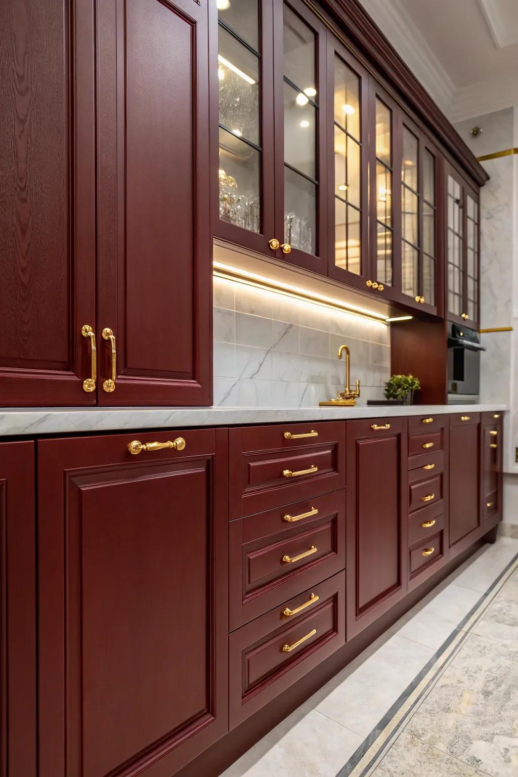 Luxurious kitchen with dark red cabinets and gold accents.