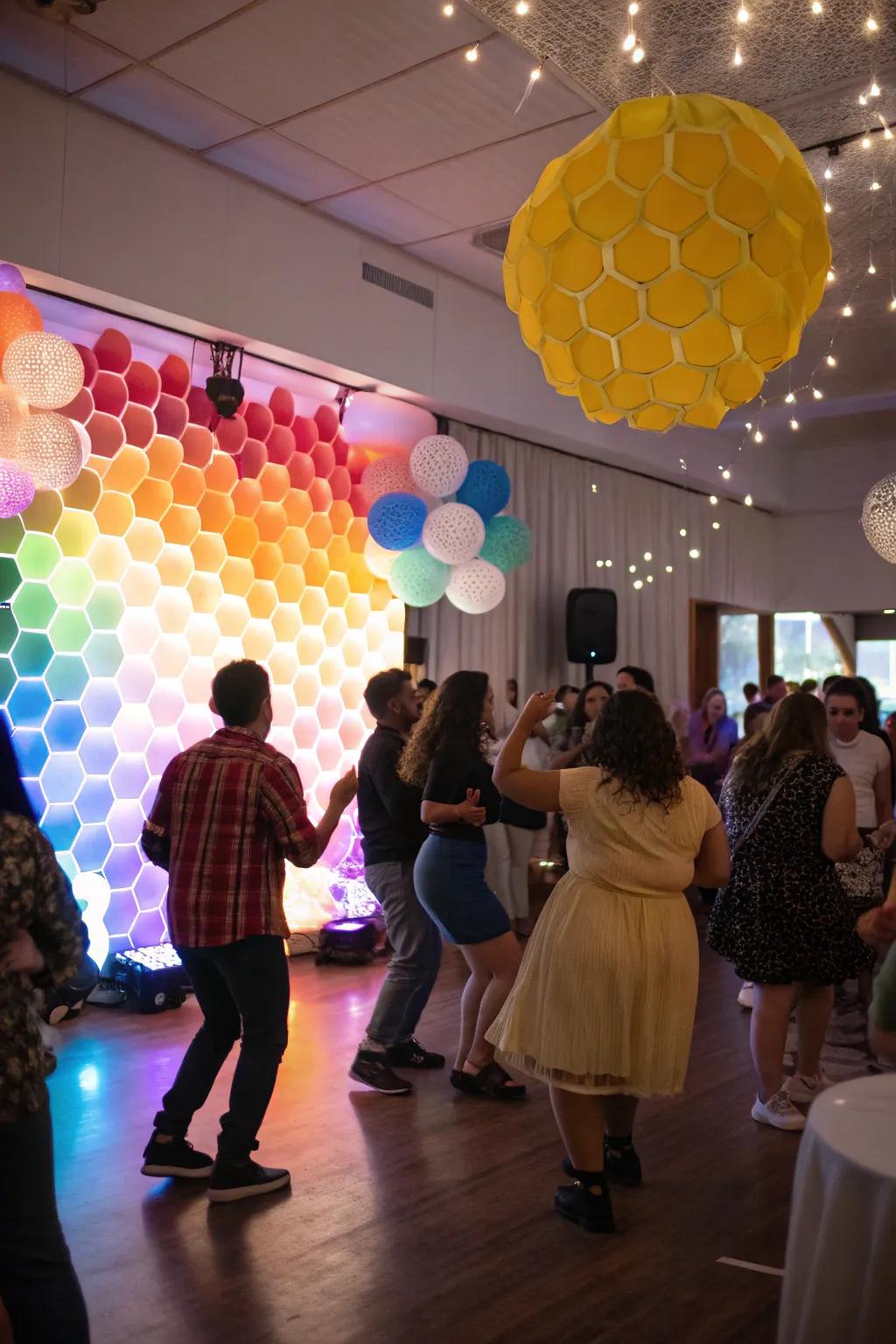 Set the mood with a vibrant honeycomb party backdrop.