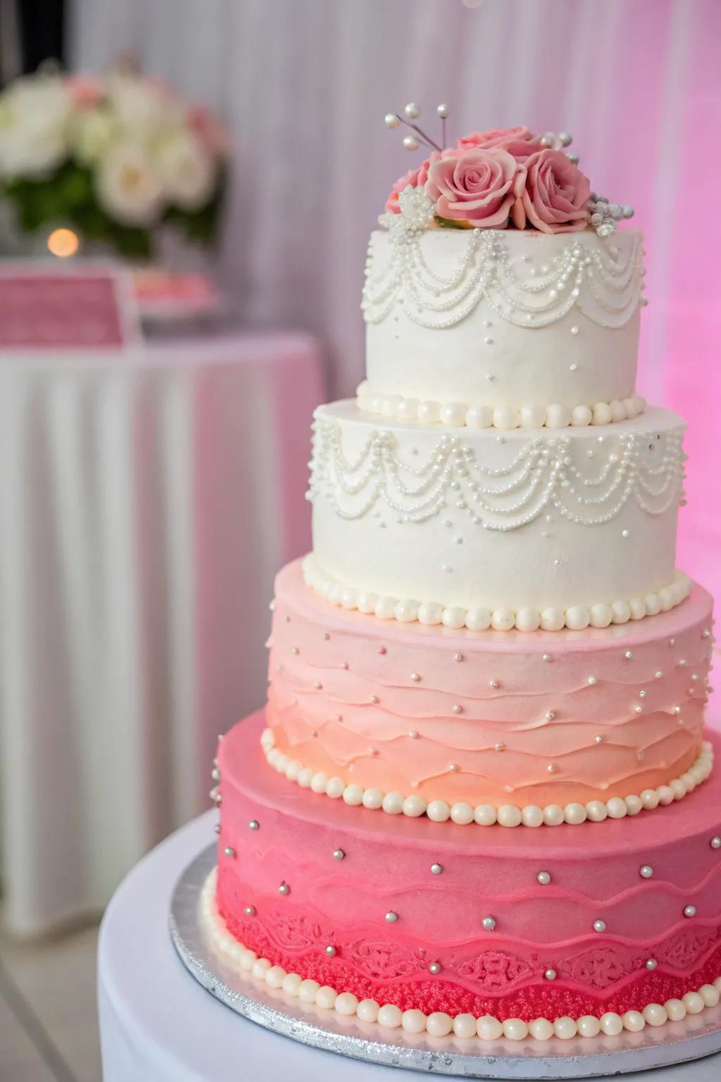A gradient wedding cake transitioning from ivory to vibrant coral.