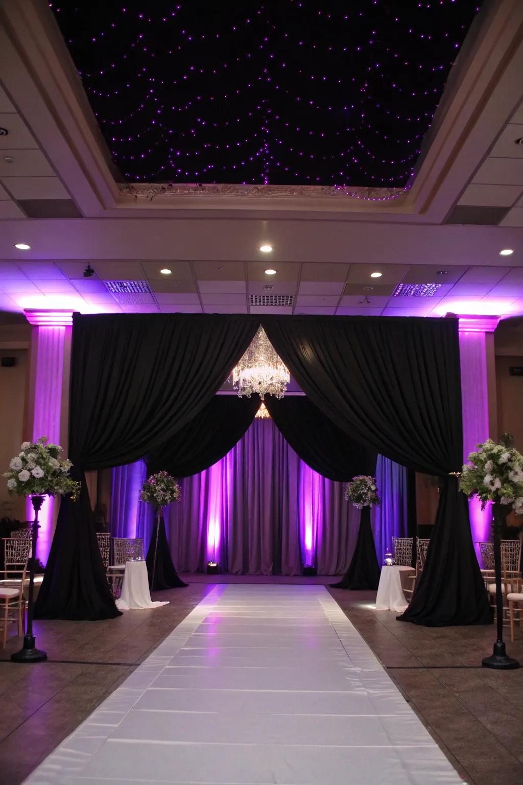 Dramatic lighting with lavender uplighting and midnight drapery.