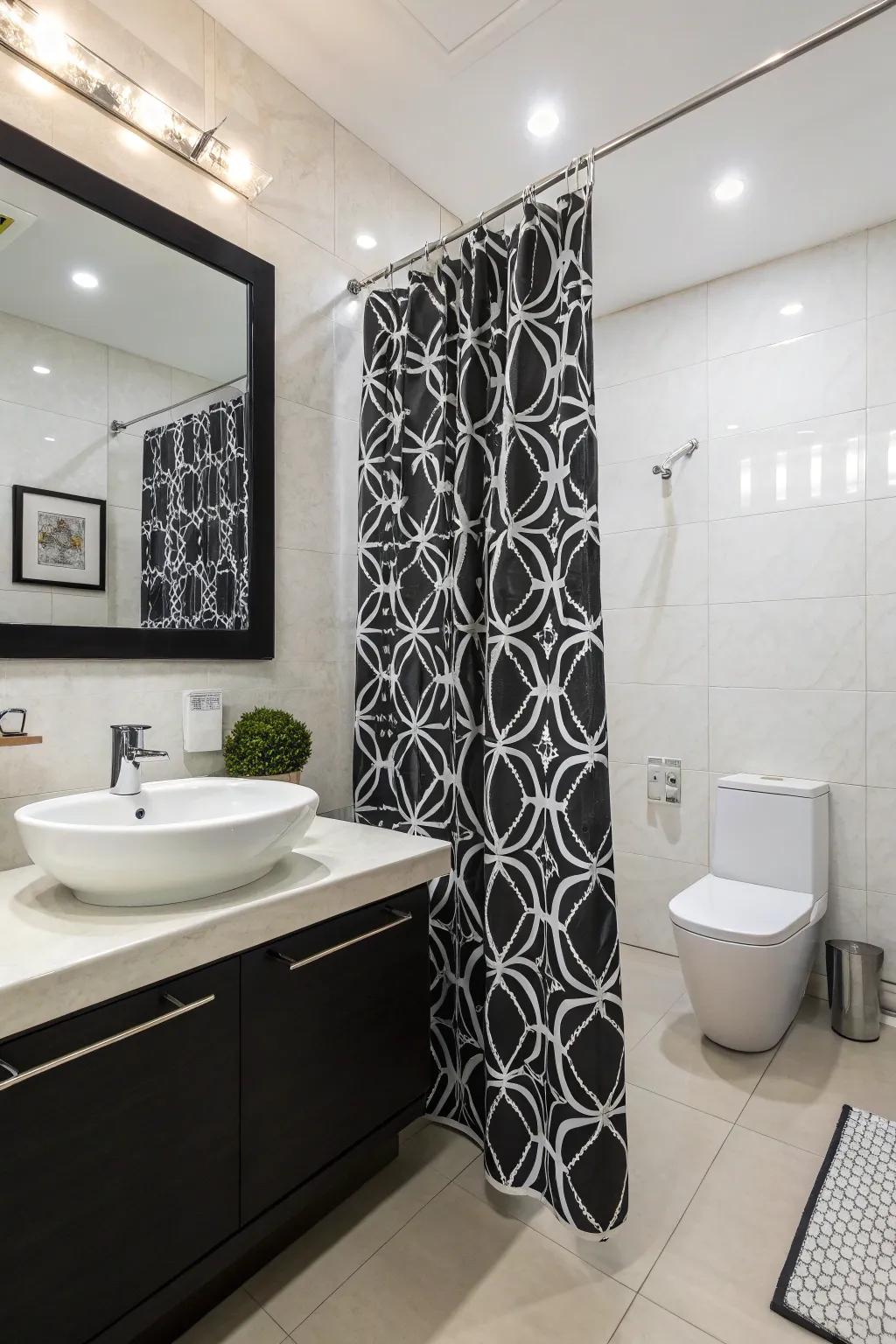 A striking black and white shower screen enhances this modern bathroom.