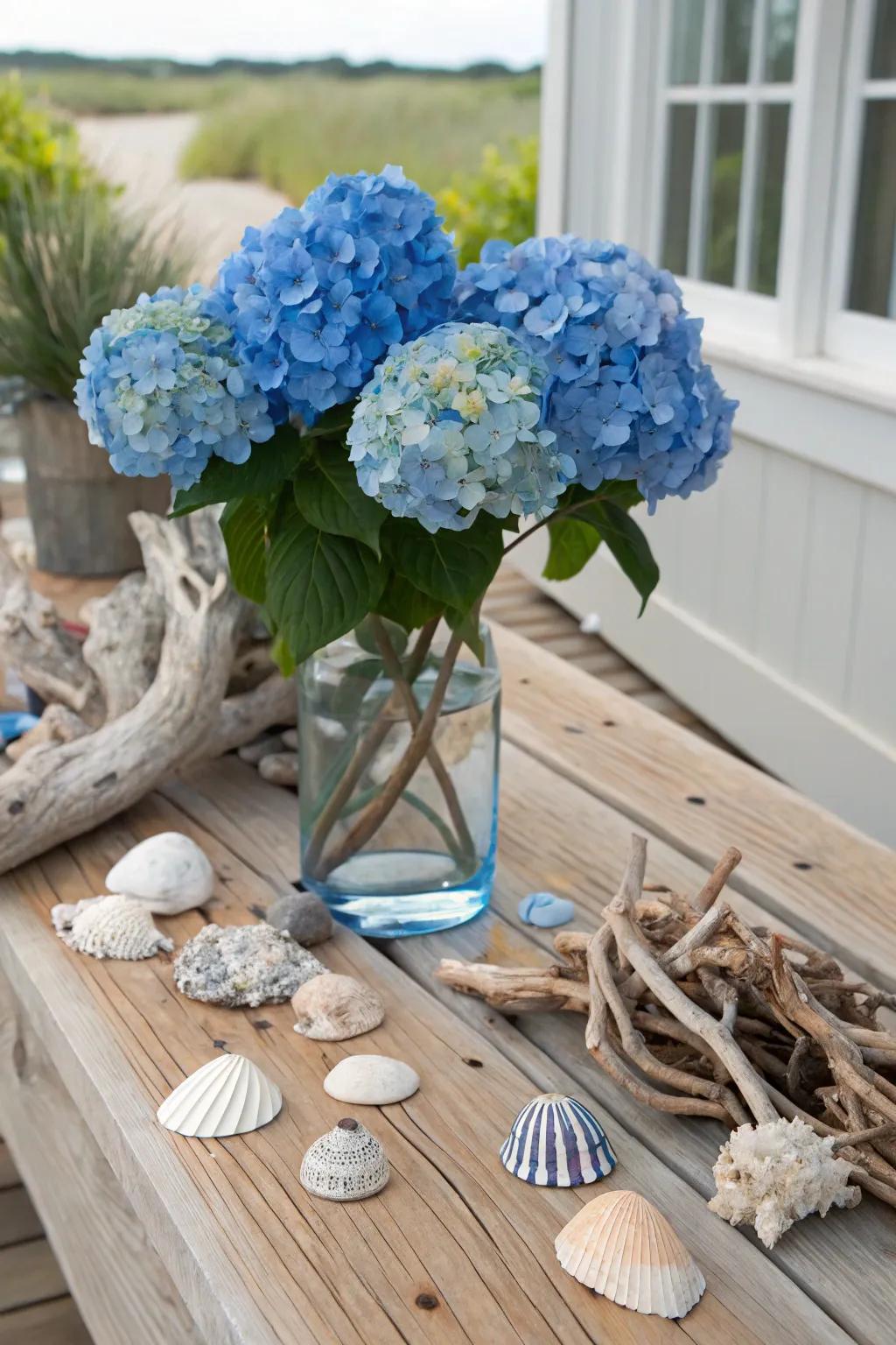 A coastal-inspired centerpiece with blue hydrangeas and seashells.