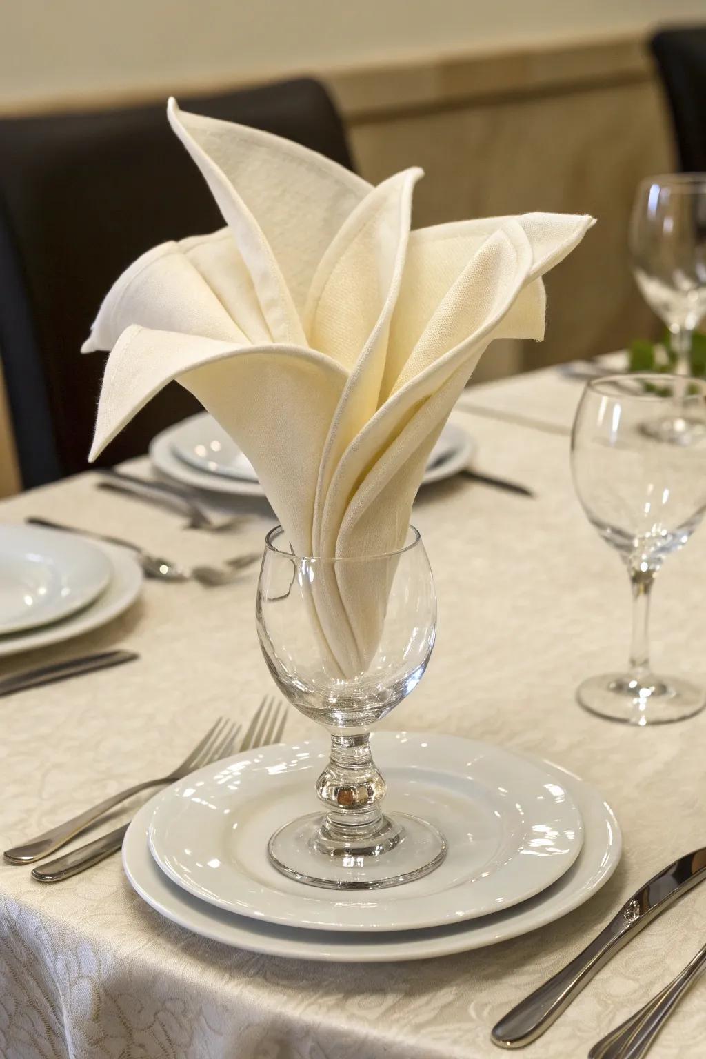 The lily goblet napkin fold adds a floral touch to your setting.